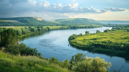 Obraz premium A river with a green valley and a cloudy sky