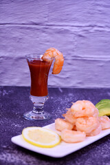 shrimp with avocado and lemon on a white plate. cocktail margarita. appetizer