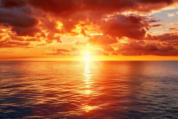 A serene scene of sunset over the ocean with clouds in the sky, great for use as a calming background or scenic landscape