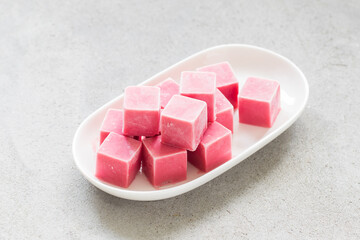 Vegan Strawberry mini ice cream in the form of cubes. On a plate. Light background	
