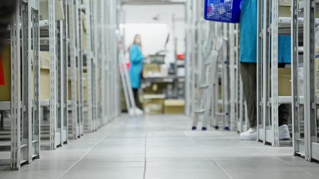 Employees navigate through aisles stocked with various products in bustling warehouse. Bright overhead lights illuminate organized shelves. Teamwork and efficiency are paramount.