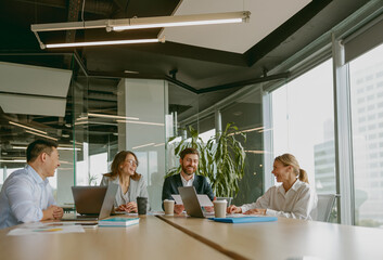 A team meeting occurs where professionals share valuable ideas and strategies in an inspiring office