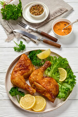 fried chicken legs with lettuce, lemon on plate