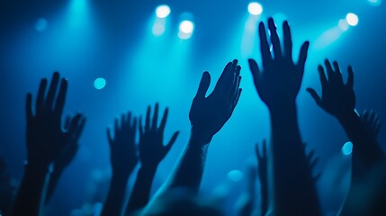 Unity in Darkness: Anonymous Close-Up of Hands Reaching at Concert Gathering Under Blue Lights