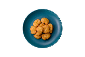 Delicious fresh crispy chicken nuggets on a dark concrete background