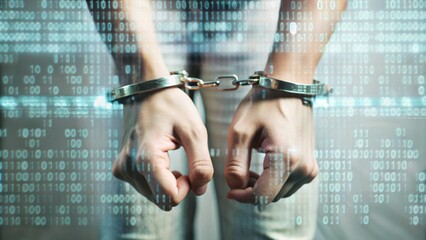 A man in a black turtleneck is handcuffed with handcuffs. Concept of an arrest for breach of cyber security.