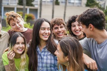 Fototapeta premium Young group of friends having fun outdoor with school university campus on background - Back to school concept - Main focus on center girl face