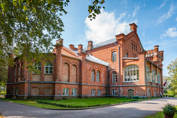 Red brick manor in Puikule, Latvia. Puikule Manor with its his­tor­ic­al am­bi­en­ce and splendid parks is a popular tourist attraction.