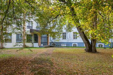 Entrance to the school building on a sunny autumn day. Voltveti manor house, Estonia.