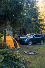 Camping Scene with SUV and Yellow Tent