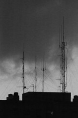Low key high noise images of a storm over a dark city.
