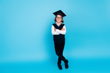 Photo of smart happy charming boy wear uniform study school folded arms isolated on blue color background