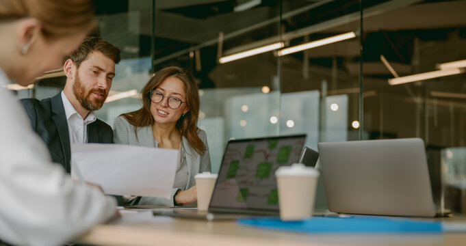 A diverse group of professionals engaging in productive discussions about strategies in a modern office space