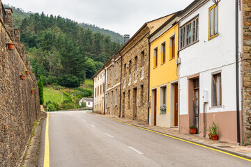 Fototapeta premium Houses aligned to the mountain road in the inland villages of Asturias, Taramundi.