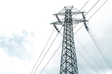 A tall metal tower standing against a clear blue or cloudy sky, suitable for use in architecture, engineering, or conceptual art projects
