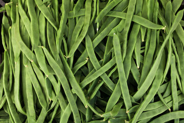 Green romano beans on the counter in the market