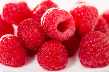 Handful of raspberry berries on white background