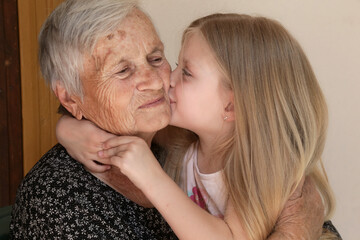 Happy family, child and great grandma hug, relax, smile, love and bond together, happy and content at home showing love and affection	