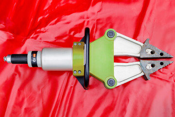 Firefighter rescue hydraulic spreader cutter on red canvas