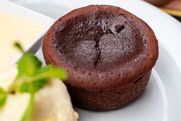 French gâteau au chocolat (chocolat cake or brownie) served with vanilla ice cream and custard