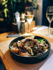 Delicious seafood platter with white wine on restaurant table