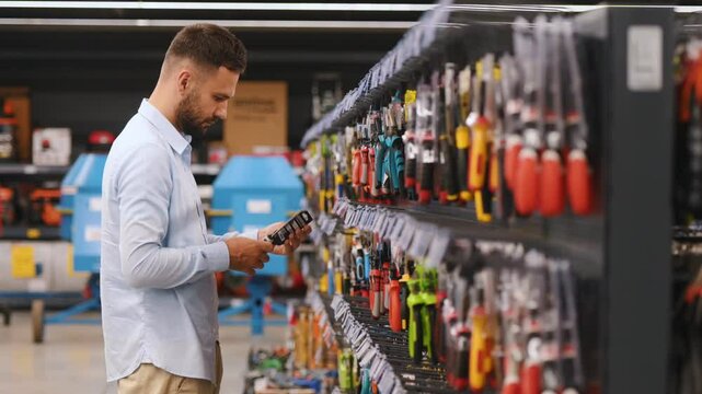 A customer in a hardware store chooses tools