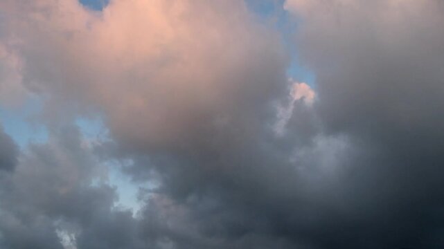Dark orange and gray clouds moving fast.View of the sky in the evening. 4K, 60Fps.