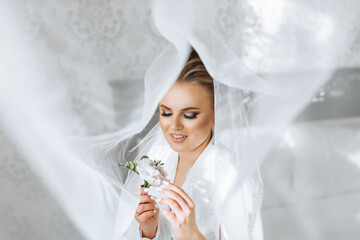 A woman is wearing a veil and holding a flower in her hand. The image has a soft and romantic mood,...