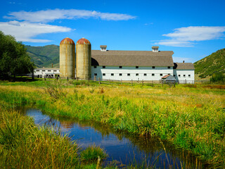 Classic Landmark Architecture of American Farmhouse over the summer brook in the Historic Park...
