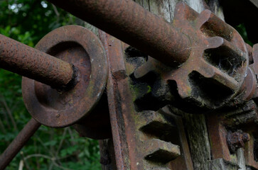 The cogs and workings of an old unused victorian sluice gate system now collecting rust.