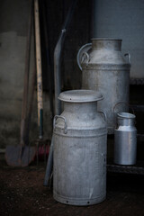 Obraz premium Different sizes of traditional milk churns on a Devon farm, UK.