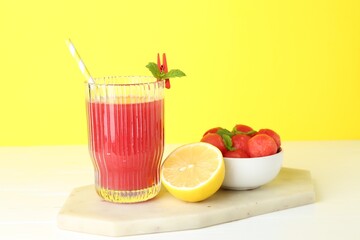 Tasty watermelon drink in glass and fresh fruits on white table