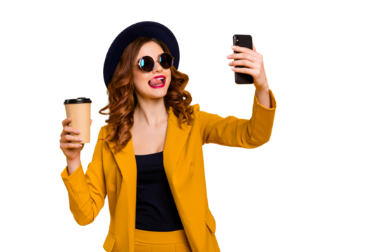 Close up photo beautiful funky she her lady hands arms telephone make take selfies tongue out mouth vacation hot beverage paper container wear specs formal-wear suit isolated yellow bright background
