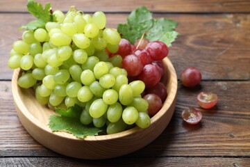 Fresh ripe grapes on wooden table, closeup