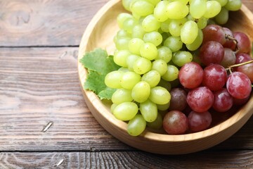 Fresh ripe grapes on wooden table, closeup