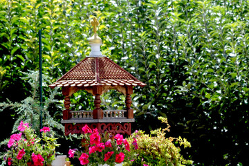 Beautiful bird feeder against the background of green vegetation