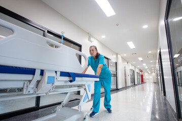Hospital staff pushes the emergency medical team working in a rush to take the emergency patient to...