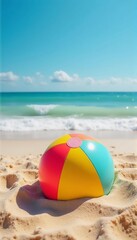 A brightly colored beach ball resting on the sand, with waves gently rolling in the background