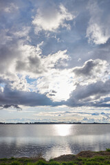 Beautiful clouds in a lagoon with the sunset Vertical