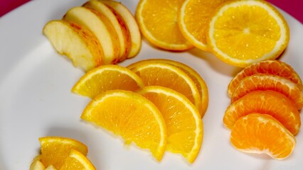organic fresh orange, apple, malta decorated on white ceramic plate with close shot 