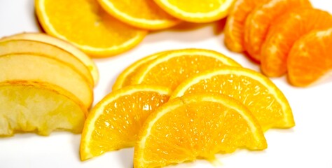 organic fresh orange, apple, malta decorated on white ceramic plate with close shot 