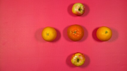 Fresh orange, apple, malta on red background 
