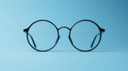 Fototapeta premium A pair of glasses resting on a blue surface