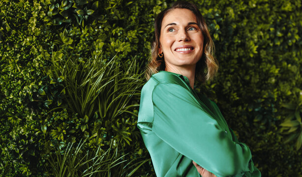 Freelancing with sustainability: Woman standing in a green coworking office