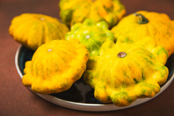 Pattypan zucchini on a textured kitchen table. squash. Fresh organic pattypan squashes on...