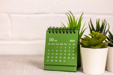The desktop calendar for October 2024 is on the table.