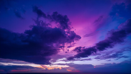 Fototapeta premium vibrant purple, magenta, violet, navy blue, and cloud-filled twilight sky vibrant sunset