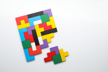 Colorful wooden puzzle pieces on white background, top view. Space for text