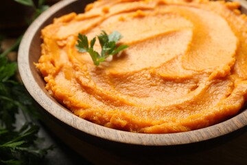 Delicious mashed sweet potatoes in bowl on table, closeup