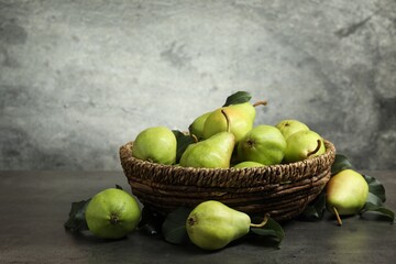 Many fresh ripe pears on grey table